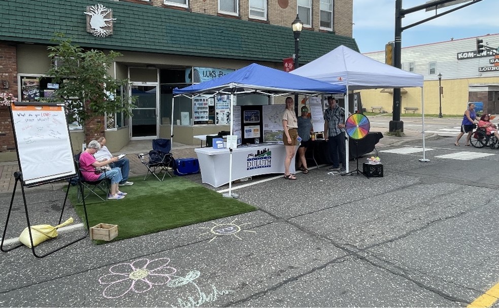 A photo of the City's booth on Grand Ave. during Spirit Valley Days 2024. The booth provided an opportunity to connect with the public and gain input about the Sprit Valley Plan.